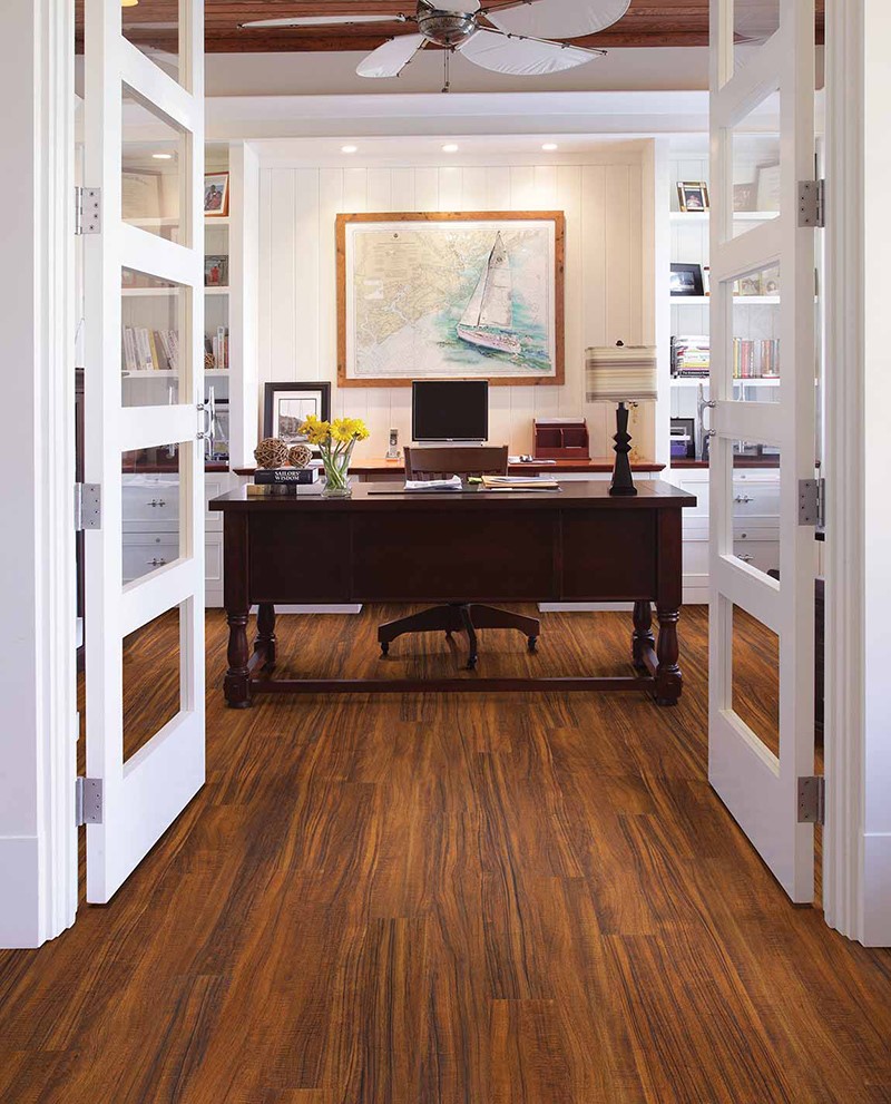 Nautical themed office with wood desk and wood flooring